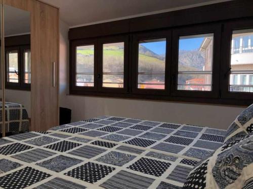 a bedroom with a bed with a view of a mountain at APARTAMENTO El Roxu 2 in Arriondas