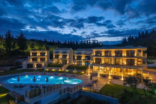 an aerial view of a hotel with a swimming pool at night at EPHYRA in Syvota