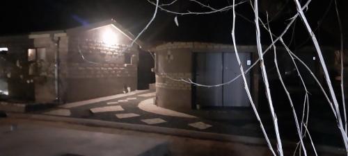 a building with a light on the side of it at night at Seqonoka Villa Accommodation & Events Park in Berea Hills