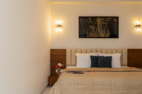 Postel nebo postele na pokoji v ubytování Blugent Residency