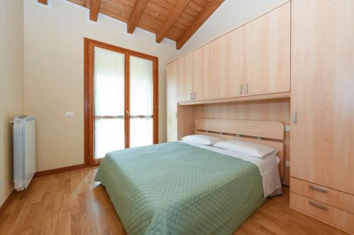 a bedroom with a bed and a large window at Apartment baglio degli ulivi in Sirmione