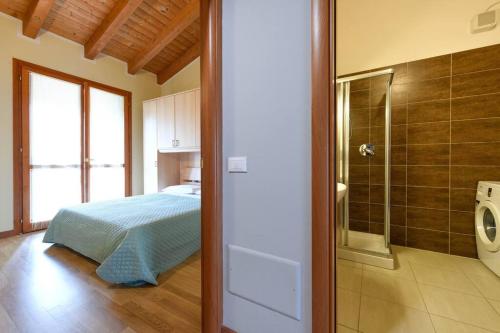 sypialnia z łóżkiem oraz łazienka z prysznicem w obiekcie Apartment baglio degli ulivi w Sirmione