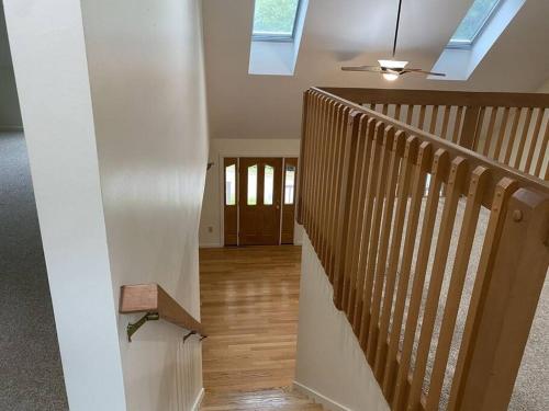 a staircase in a house with a skylight at Beautiful Spacious Home w/ Game Room. in Gilford