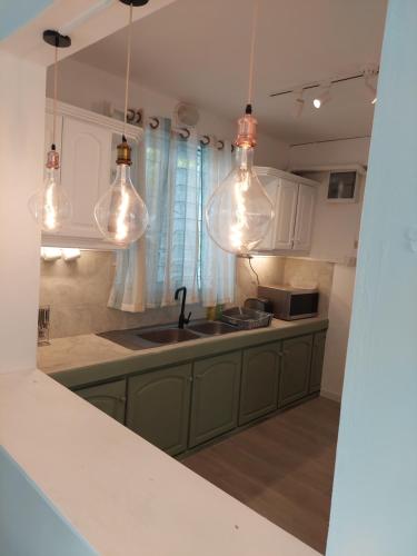 una cocina con fregadero y algunas luces en Blue Paradise, en Blue Bay