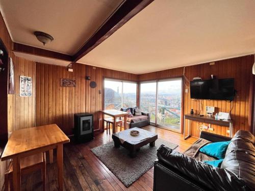 a living room with a couch and a table at Patagonia Nice View in Puerto Montt