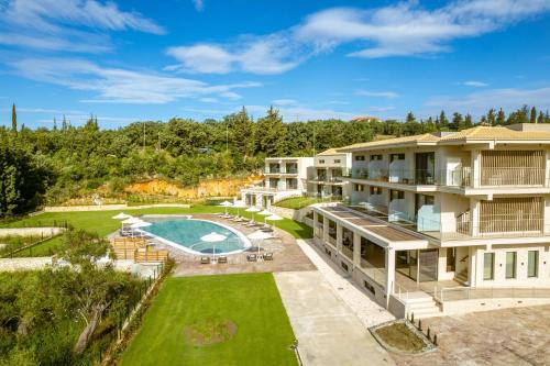 an aerial view of a resort with a pool and yard at EPHYRA in Syvota