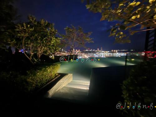 a nightime view of a park with a city skyline at Edge Central Pattaya by JJJ in Pattaya Central
