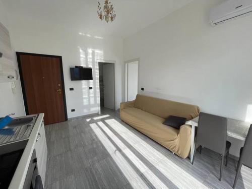 a living room with a couch and a table at Winter in Vado Ligure
