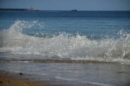 a wave in the ocean on a beach at Hotel Sunset Beach in Punta del Este
