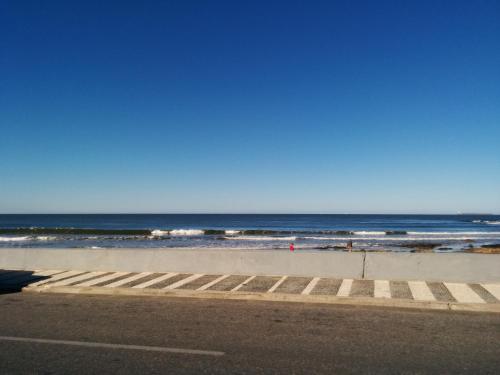 a beach with the ocean in the background at Hotel Sunset Beach in Punta del Este