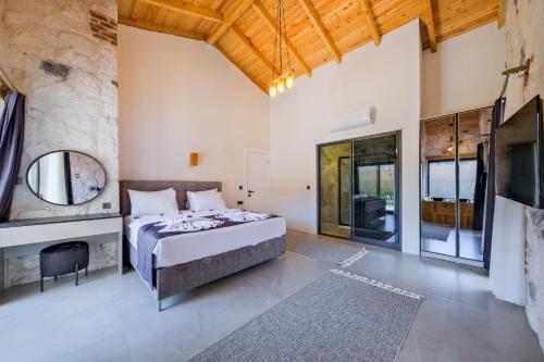 a bedroom with a bed and a large stone wall at Fethiye Villa Ka Exclusive 2 in Fethiye
