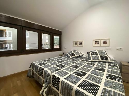 a bedroom with a bed with two pillows on it at APARTAMENTO El Roxu 2 in Arriondas