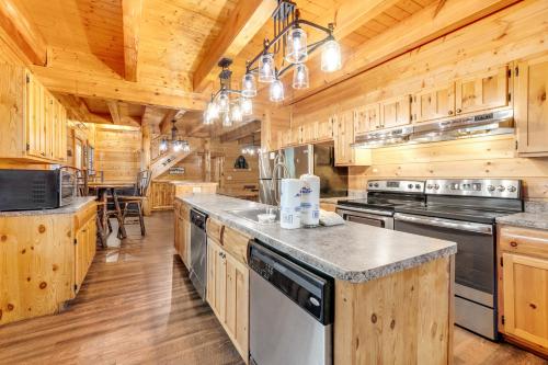 a kitchen with wooden cabinets and appliances in a cabin at Valhalla Manor in Pigeon Forge