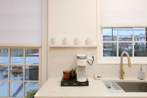 a kitchen with a coffee maker on a counter at Queen Anne's Condo in Savannah