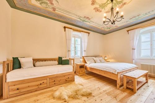 two beds in a room with a ceiling at Chalupa Fara in Dolní Malá Úpa