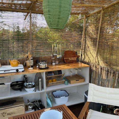 a kitchen with a counter in a tent at La Prairie Étoilée Luxury Glamping - Adults Only in Crozon-sur-Vauvre