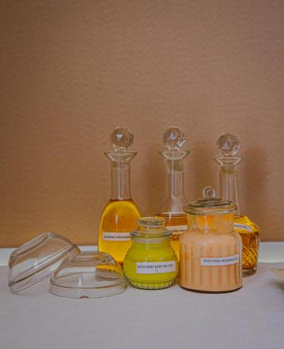 a group of glass bottles and jars of honey at The Rawla Narlai - A Luxury Heritage Stay in Leopard Country in Nārlāi