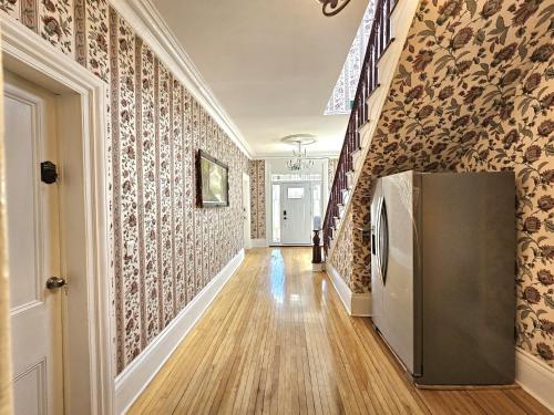 a hallway with a refrigerator in a house at Sunflower Guest Suites in Summerside