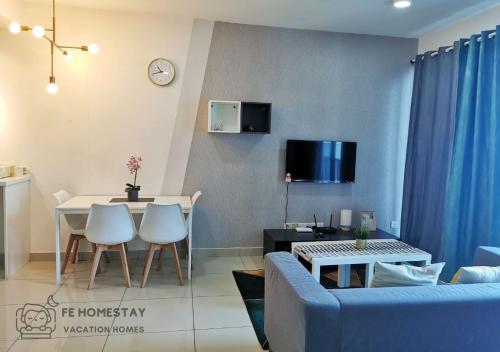 a living room with a blue couch and a table at Netflix WiFi Cozy Homestay Trefoil Setia Alam Shah Alam 沙亚南舒适温馨日租民宿 in Setia Alam