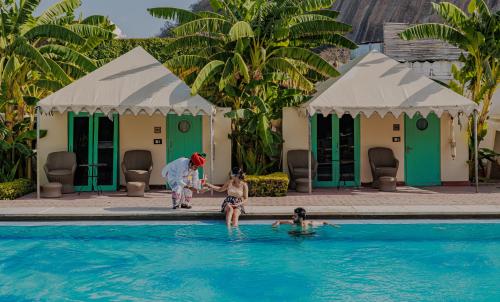 a woman and a child playing in a swimming pool at The Rawla Narlai - A Luxury Heritage Stay in Leopard Country in Nārlāi