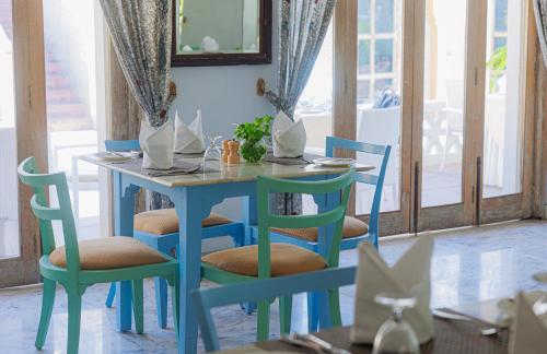 a blue table and chairs in a dining room at The Rawla Narlai - A Luxury Heritage Stay in Leopard Country in Nārlāi