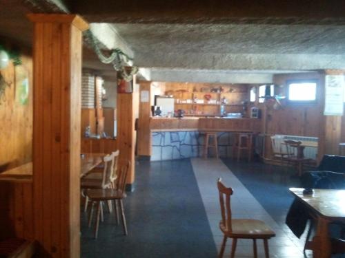 a restaurant with a bar and some chairs and tables at Kris Guesthouse in Stoykite