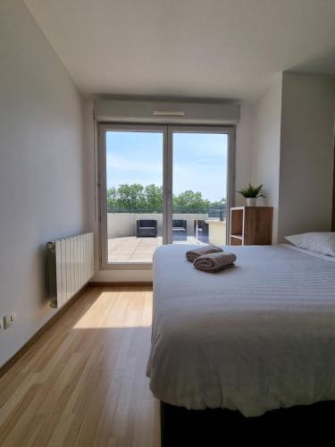 a bedroom with a large bed and a large window at Immense RoofTop Lyon 3 chambres, 4 places de parking in Lyon