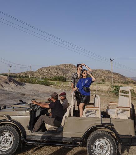 a group of people standing in the back of a jeep at The Rawla Narlai - A Luxury Heritage Stay in Leopard Country in Nārlāi