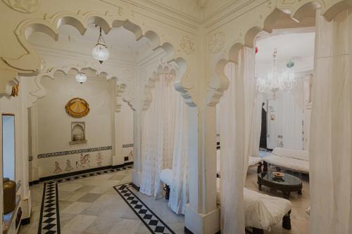a bedroom with a bed with curtains in it at The Rawla Narlai - A Luxury Heritage Stay in Leopard Country in Nārlāi