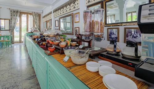 a buffet line with bowls and dishes on it at The Rawla Narlai - A Luxury Heritage Stay in Leopard Country in Nārlāi