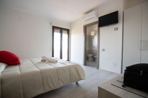a bedroom with a bed with a teddy bear on it at La Finestra Sul Mare in Lanusei