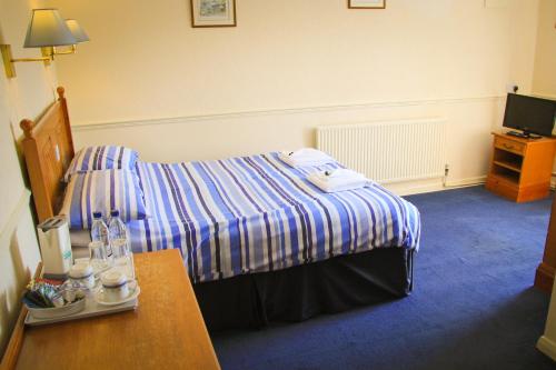 a hotel room with a bed and a table at The Red Lion in Lowick Green