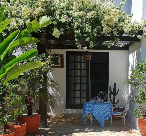 a table and chairs in a courtyard with plants at Andorinhas "Mini casa de hóspede" in Niterói