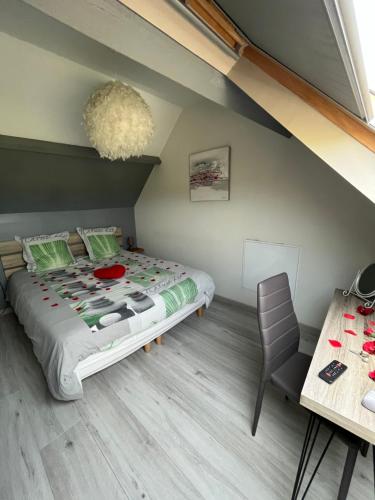 a bedroom with a bed and a table at Un moment zen à Warhem in Warhem