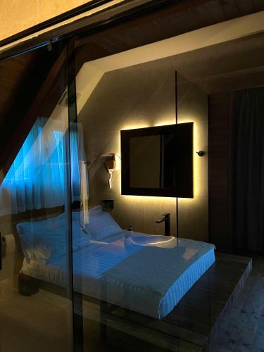 a bedroom with a bed with a tv on the wall at Molla Guest House in Theth