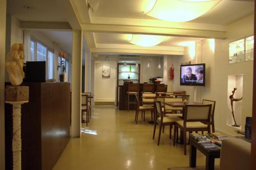 a restaurant with chairs and a table and a dining room at Telmho Hotel Boutique in Buenos Aires