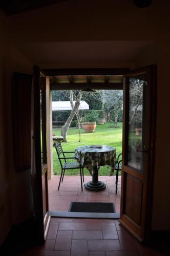 an open door to a patio with a table and chairs at La Fattoressa in Florence
