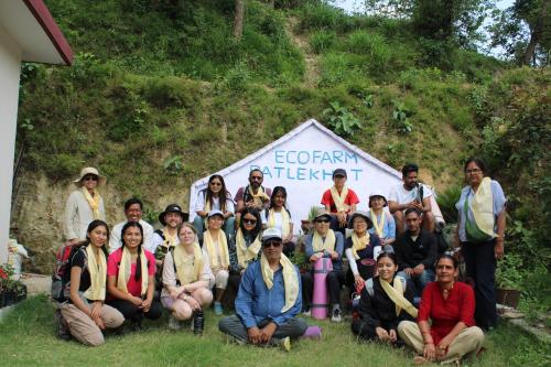 a group of people posing for a picture in front of a sign at Patlekhet Eco Farmhouse in Dhulikhel