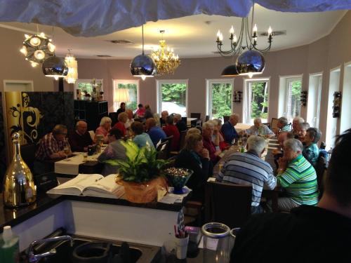 a group of people sitting at tables in a room at Hotel Haus Hubertus in Schneverdingen