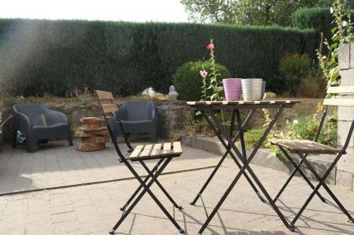 a table and two chairs and a table and chairs at Gîte 'Toi et moi ' in Graux