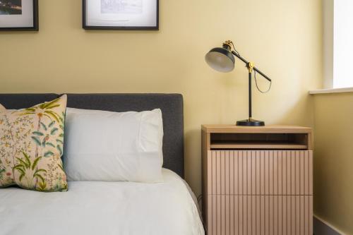 a bedroom with a bed with a lamp on a night stand at Central waterside in Oxford