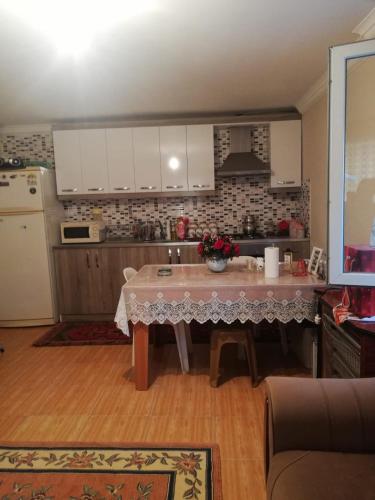 a kitchen with a table in the middle of a room at Frien Haus in Kumluca