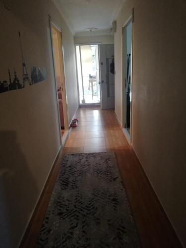 a hallway with a rug on the floor in a house at Frien Haus in Kumluca