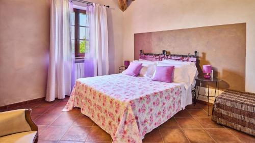 - une chambre dotée d'un lit avec une couverture rose et blanche dans l'établissement Il Passo Degli Ulivi, à Civitella Marittima