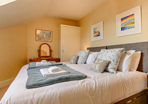 a bedroom with a large bed with towels on it at Skyes House in Southwold