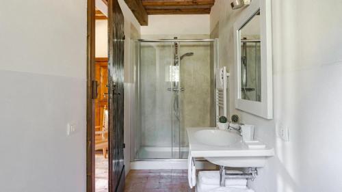 a white bathroom with a sink and a shower at Villa Collombroso in Porano