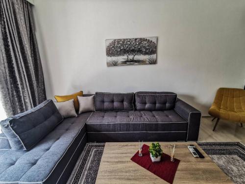 a living room with a couch and a table at Silver Central Apartment in Volos