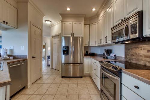 a kitchen with white cabinets and a stainless steel refrigerator at Love View in Sevierville