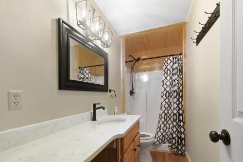 a bathroom with a sink and a mirror at Knot A Kabin in Pigeon Forge