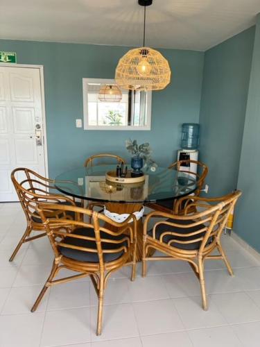 a dining room with a glass table and two chairs at Lovely Penthouse with incredible view in San Andrés